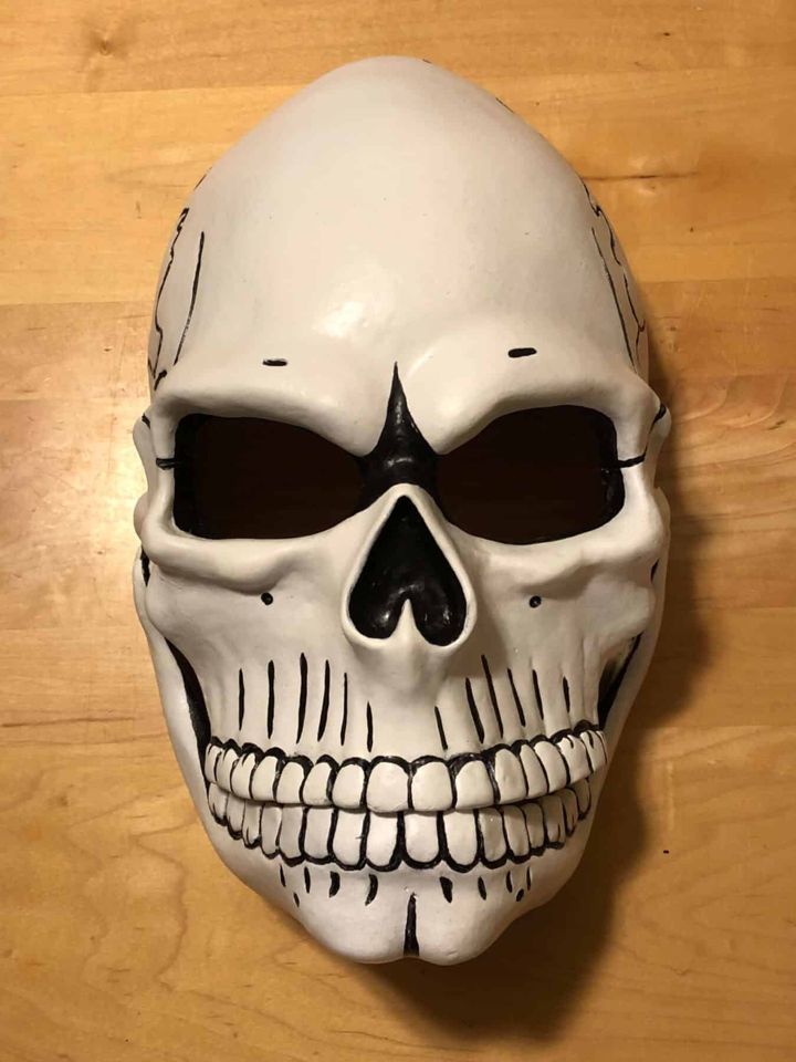 Painted skull mask with black linework