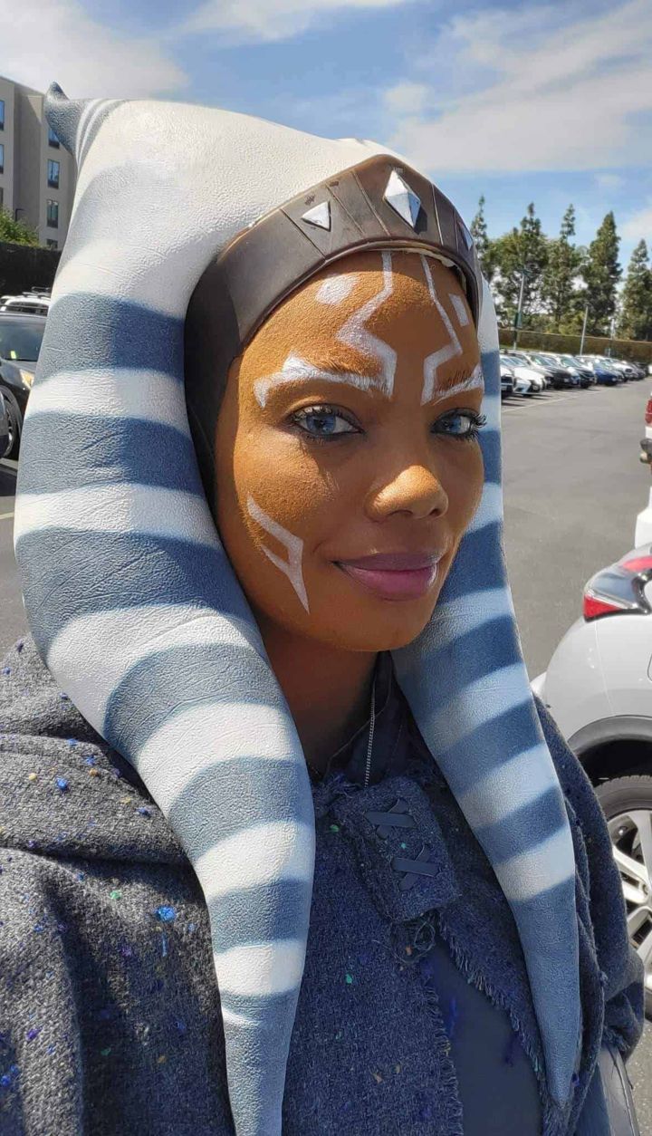 Cosplayer wearing a live-action Ahsoka Tano headpiece with white montrals and striped lekku