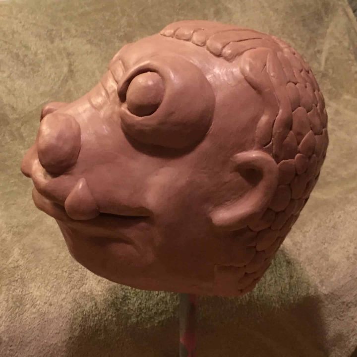 Snaggletooth clay sculpt at three-quarter view