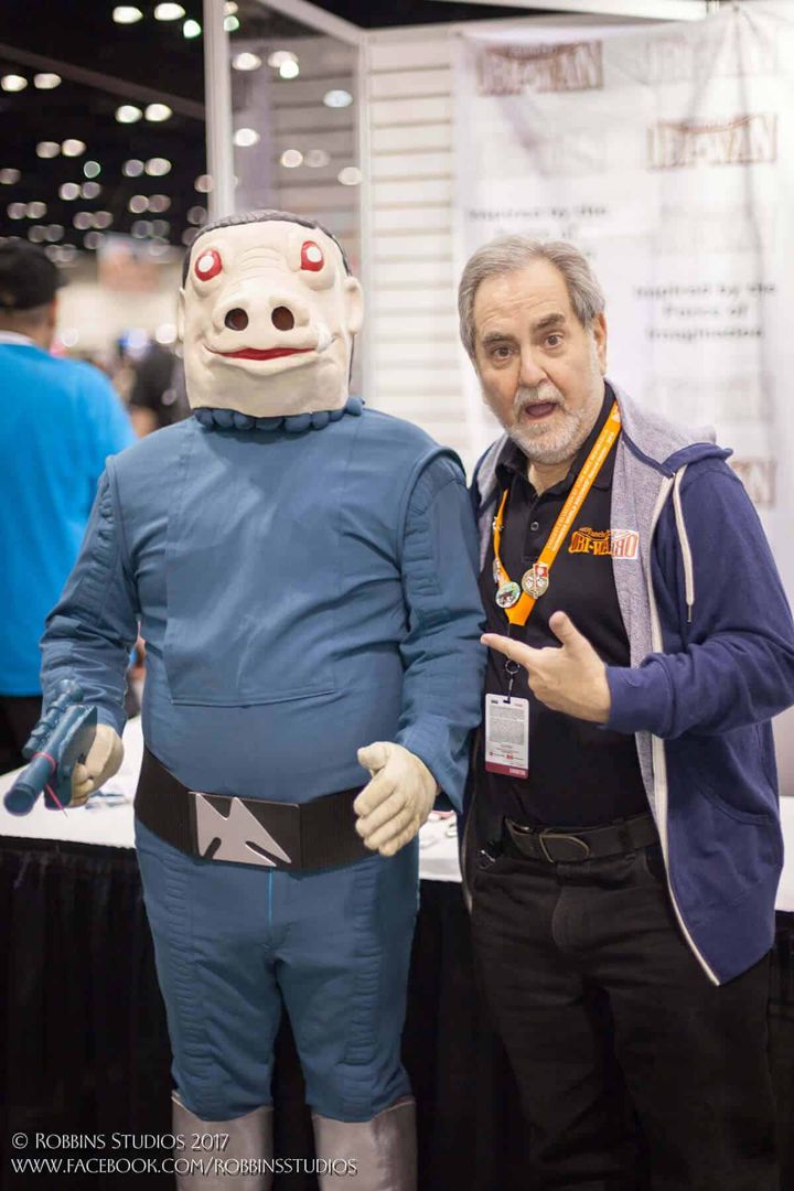 Snaggletooth cosplayer posing with a fan
