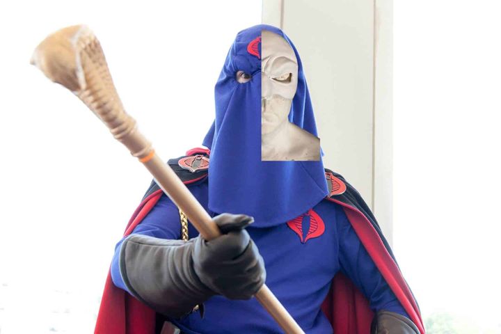 Cobra Commander cosplayer in blue hood holding a scepter