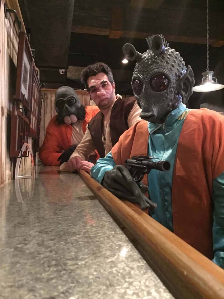 Cantina cosplayers including Evazan gathered at a bar