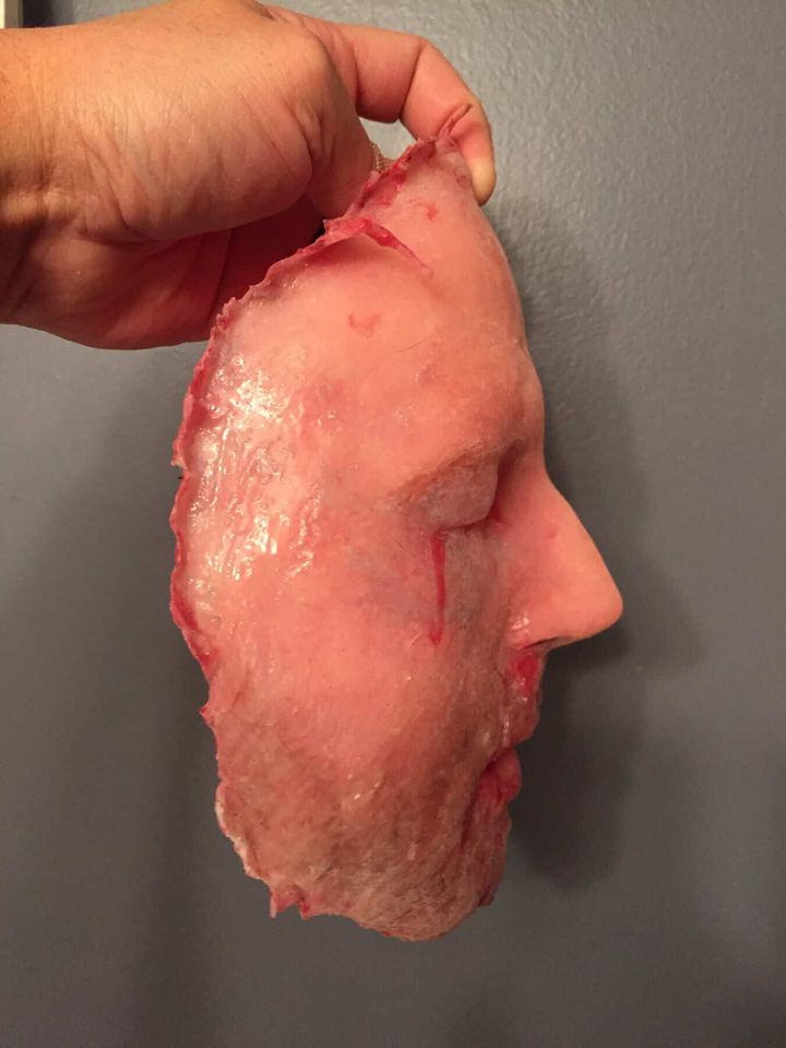 Silicone face replica held up in profile