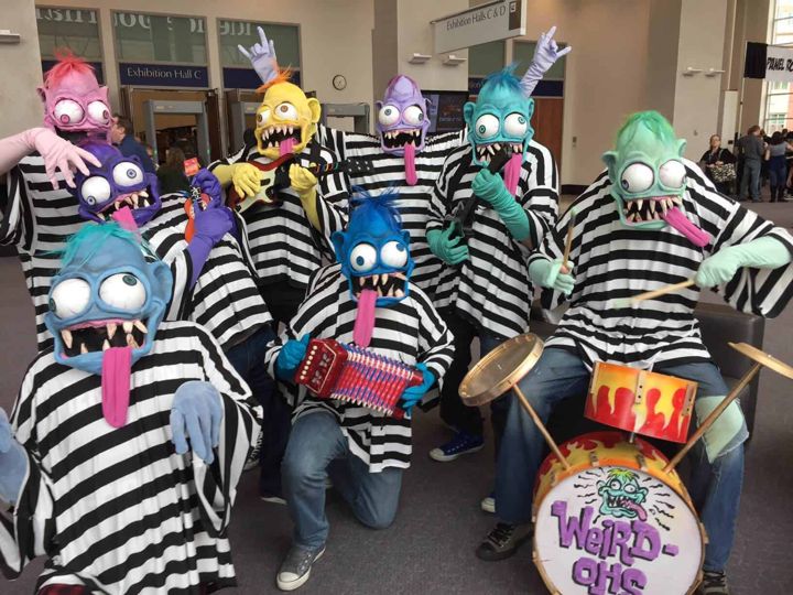 Group of cosplayers in colorful Weird-Oh monster masks and striped shirts