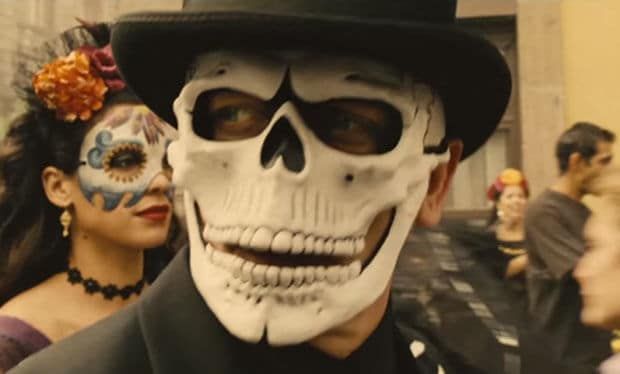 Day of the Dead skull mask worn with a top hat at an event